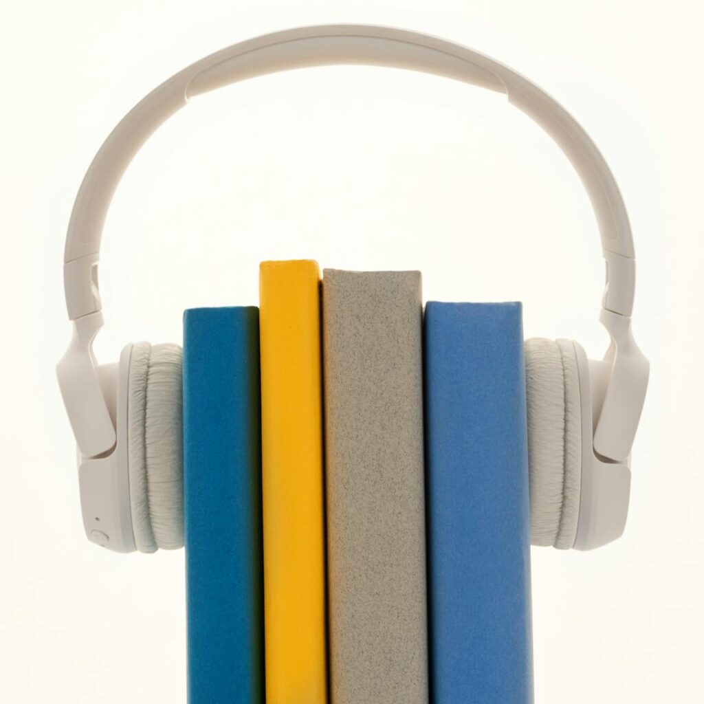 Set of 4 books with headphones on "listening" to books.